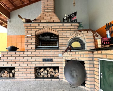 a brick oven with a pizza oven and a pizza oven