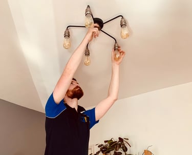 GigaVolt electrician installing a decorative light fitting