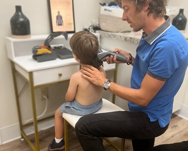 Franklin chiropractor doing insight scans on a small child to find subluxations