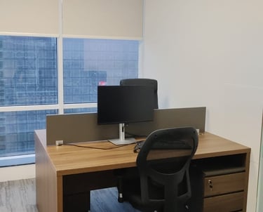 a desk with a computer and a laptop