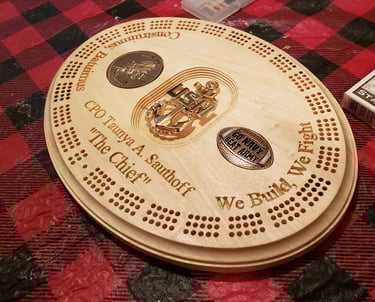 A custom gift for a retired Navy Seabee, a working cribbage board with inset coins.