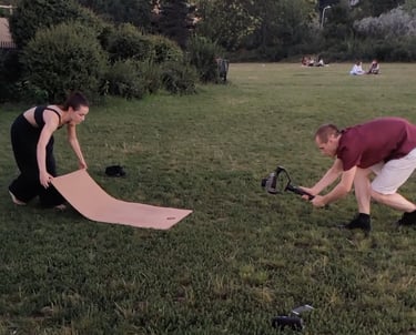 two people are filming a marketing ad using a gimbal and yoga mat