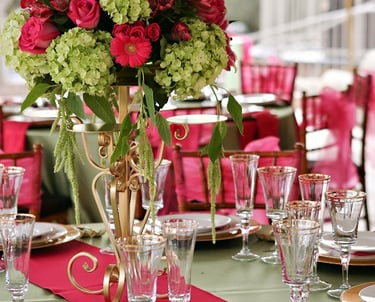 wedding table setting with fuschsia and sage linens and flowers