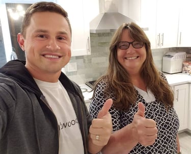 Happy customer posing with Alex, Vision Flooring. On the background brand new kitchen