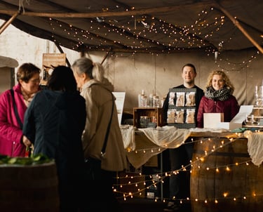 a group of people standing around a table with wine glasses