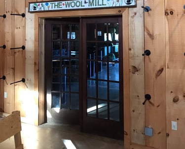 French doors retrofitted into doorway in barn business by Golden Rule Construction