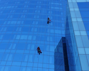 a man is hanging from a high riser