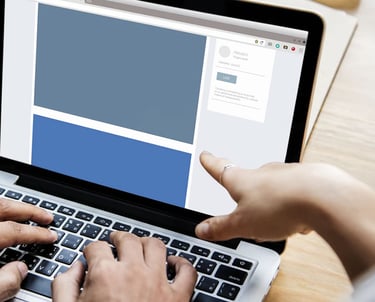 a person is typing on a laptop computer screen