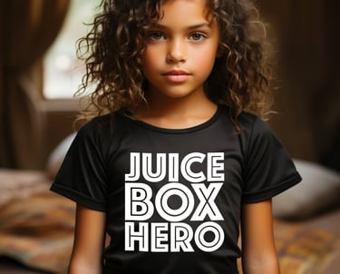 Beautiful little girl wearing a black t-shirt with stylized lettering that reads "Juice Box Hero."