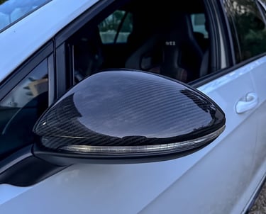 a car with a black and white car door mirror