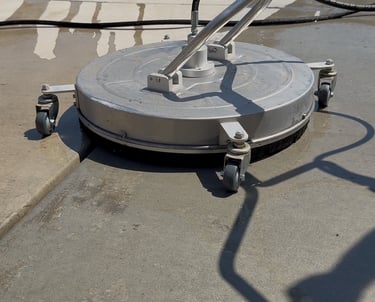 surface washer on the concrete cleaning the driveway