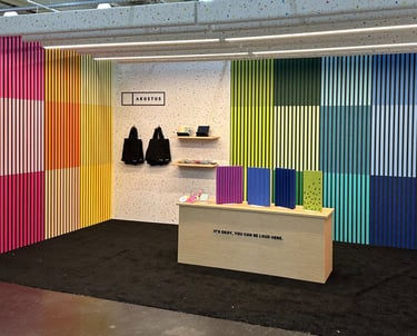 rainbow colored slatted madera acoustic panels AKUSTUS icff