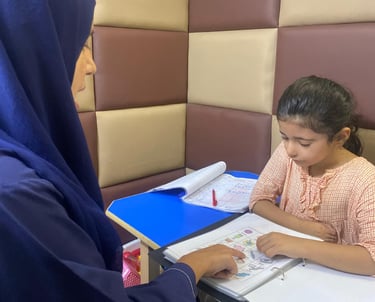 Therapist guiding young girl during session
