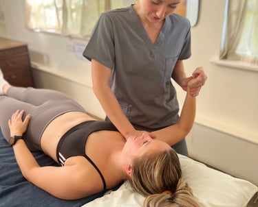 osteopath assessing patient and providing treatment in clinic room