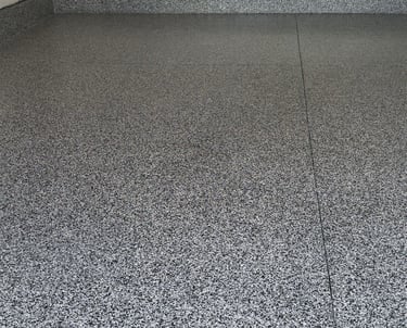 After of Home garage with domino flake floor in Grand Island home.