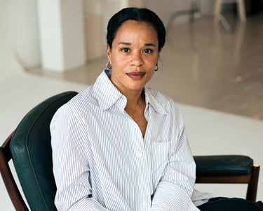 Edda Pay CCO Angel Marita Kirkegaard sitting in a chair with a black chair