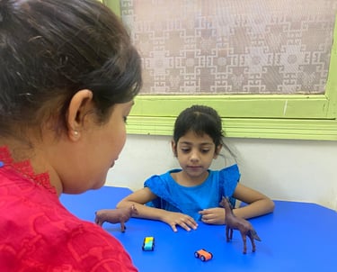 Child interacting with colorful therapy materials