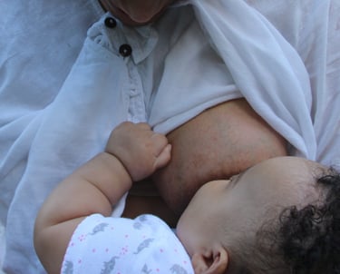 Iveth nursing her daughter