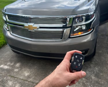 Automotive locksmith unlocking car door and making replacement keys in North Florida