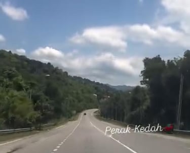 a car driving down a highway with a sky background