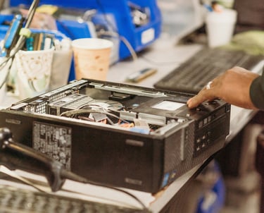 PC repair technician diagnosing a desktop computer on a workbench at PCWorkbench in Alexandria, VA.