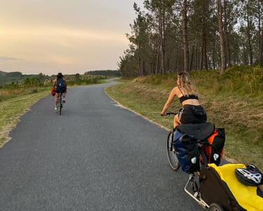 Two persons riding bikes on a beatiful road