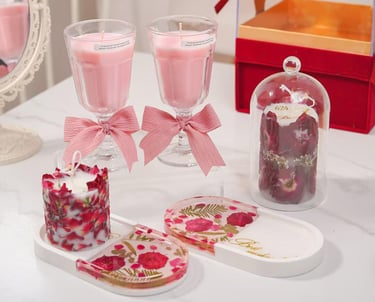 a table with a glass vase and a candle