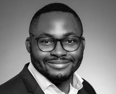 a man in a suit and glasses smiling