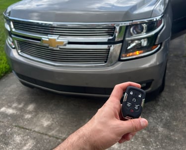 Automotive locksmith unlocking car door and making replacement keys in North Florida
