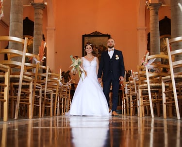 a bride and groom walking down the aisle of a church