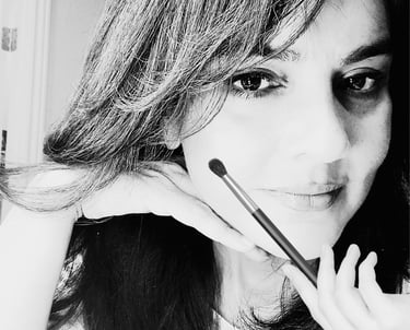 Shazia Ittiq, licensed permanent makeup artist in Oklahoma City, smiling at her desk
