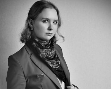 a woman in a suit and scarf with a scarf around her neck