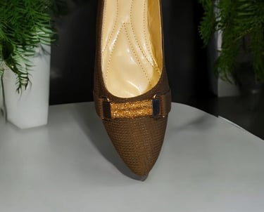 a pair of shoes with a brown shoelaced shoe