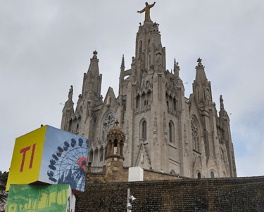 a large Tibidabo church building with a statue of a statue of a person on top of it