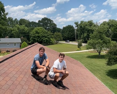 two men sitting on a roof