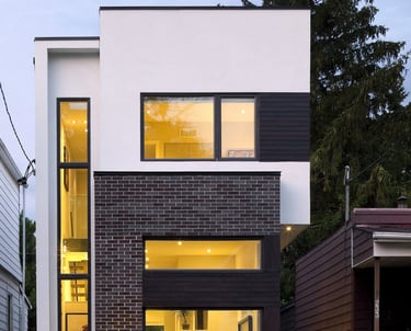 a house with a large window and a small patio