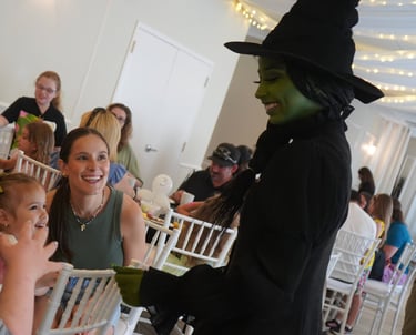 Elphaba talking with guests during a dining experience