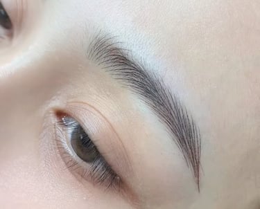 Close-up of perfect nano brows with crisp, realistic hair strokes.