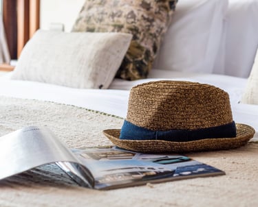 Curated luxury travel lifestyle detail with natural textures, evoking slow travel