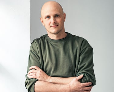 CTO Daniel Bodner standing against wall