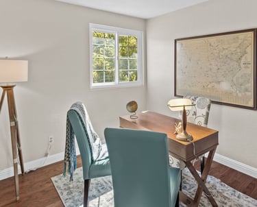 a desk with a lamp on a table