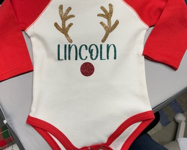 Infant's baseball onesie, white with red sleeves, personalized with child's name and reindeer antlers and nose.