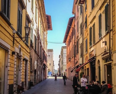Colorful street with cafes and historic buildings in Pietrasanta Tuscany Italy.