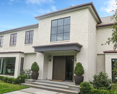 a white house with a large front door and a large front door