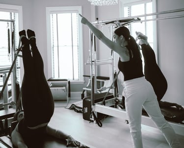 photo of 27 Pilates owner and instructor Tina Blondin giving a semi private reformer class