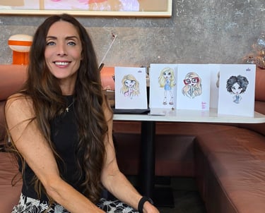 a woman sitting on a couch in a room in a resturaunt of some illustrations she has drawn