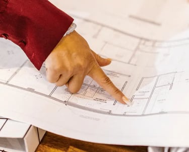Home buyers reviewing a detailed floor plan before purchase