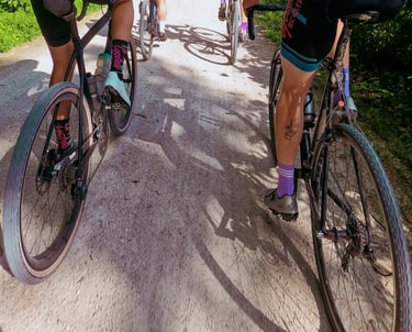 Photo taken in between two rows of bikers riding on a trail
