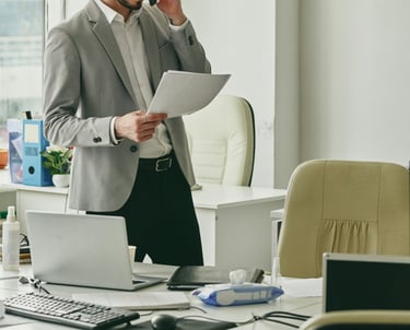Young businessman talking consulting with a client on the phone and looking at documents.and