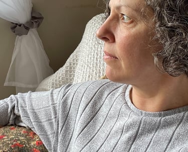 the founder of Foto Furnished Emma looking ahead, resting on one of her own handmade poppy cushions